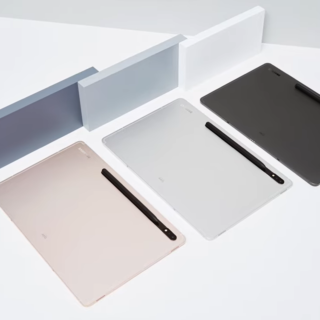three tablets of white, black, and rose gold colors on a white table