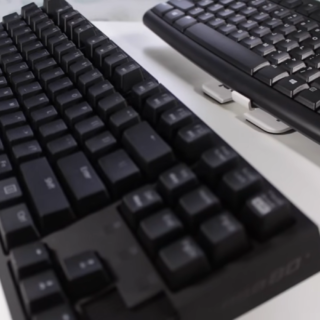 two black keyboards on a white desk