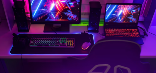 computer and laptop on the desk with colorful neon pictures