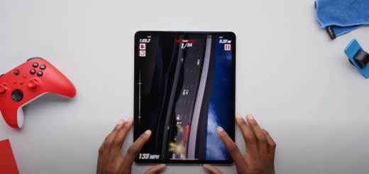 Hand playing games on an iPad Air on a table